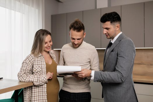 pexels-photo-7641841-7641841 A realtor presents a property contract to a young couple in a modern indoor setting, discussing details.